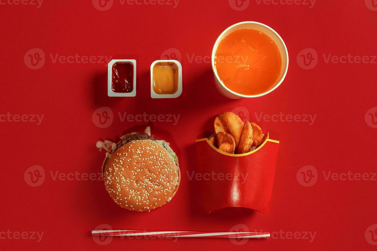 Burger and Chips. Hamburger and french fries in red paper box. Fast food on red background. photo