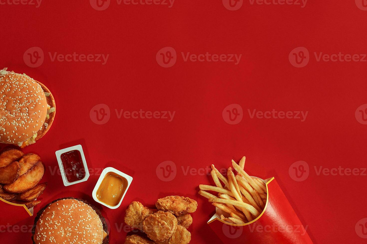 Burger and Chips. Hamburger and french fries in red paper box. Fast food on red background. photo