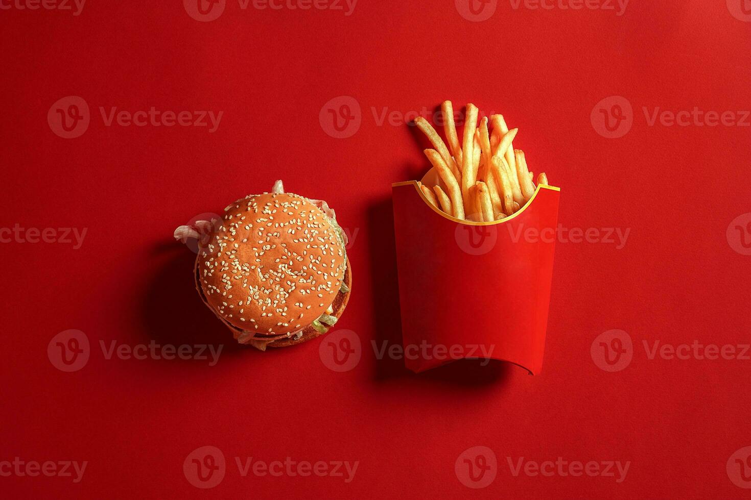 Concept of mock up burger and french fries on red background. Copy space for text and logo. photo