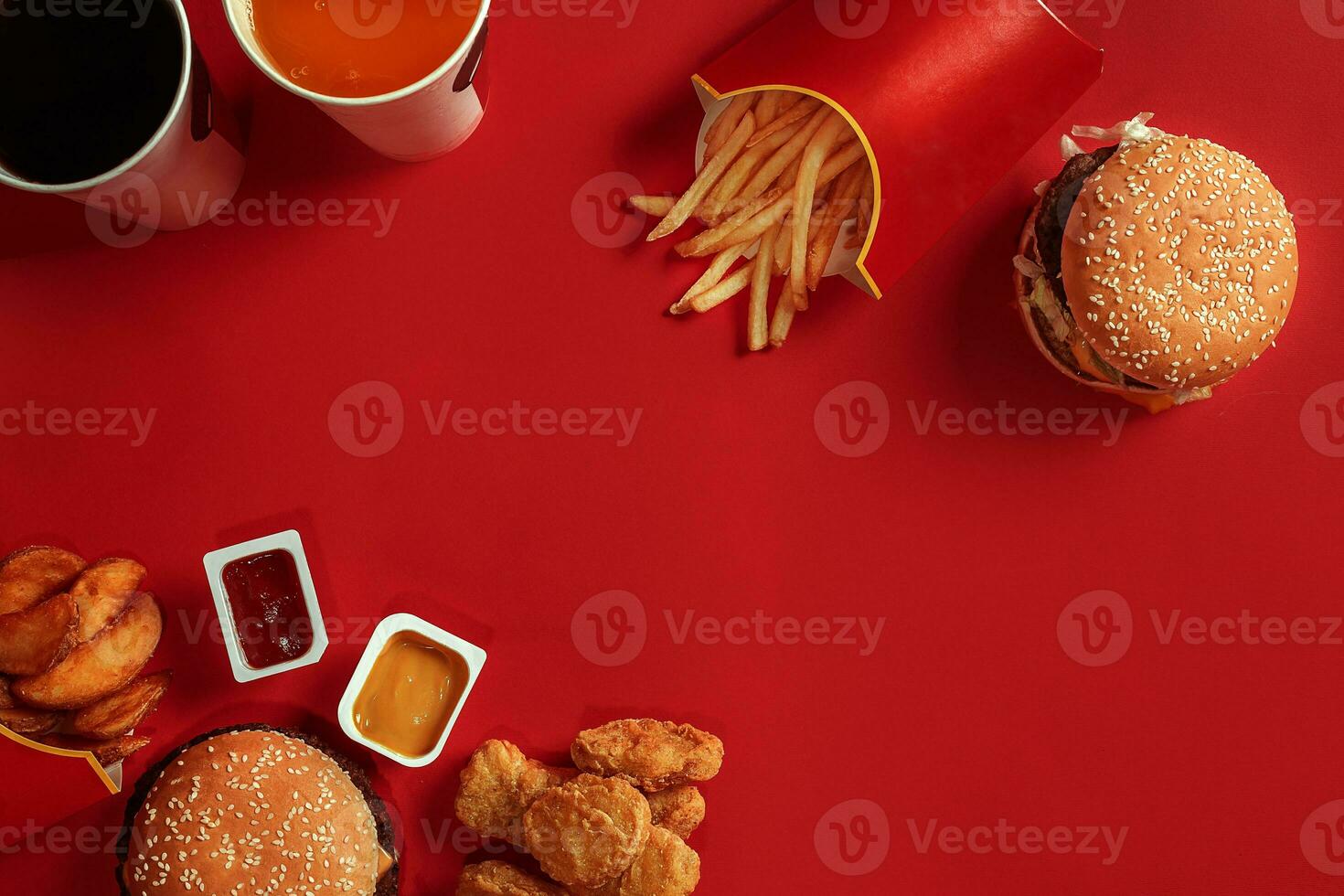 Burger and Chips. Hamburger and french fries in red paper box. Fast food on red background. photo