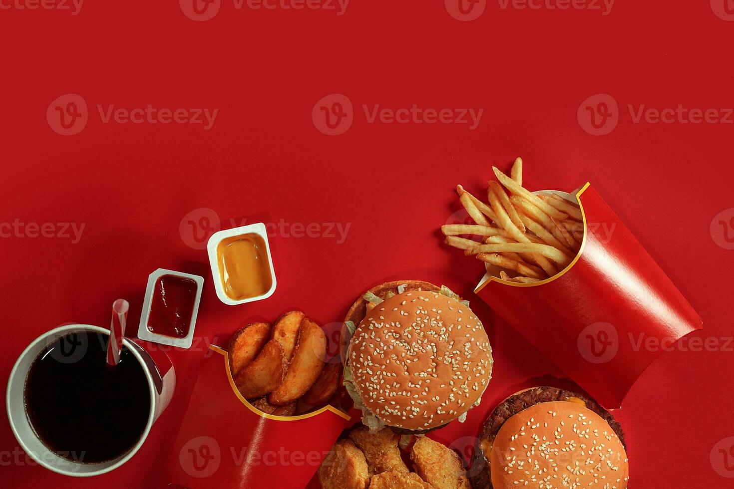 Burger and Chips. Hamburger and french fries in red paper box. Fast food on red background. photo