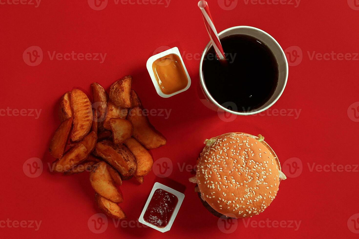 Burger and Chips. Hamburger and french fries in red paper box. Fast food on red background. photo