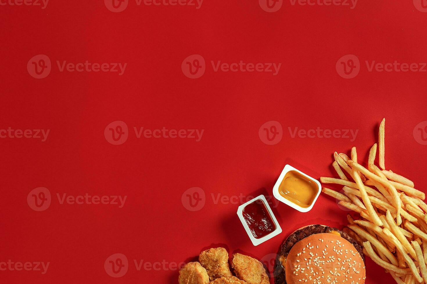 Burger and Chips. Hamburger and french fries in red paper box. Fast food on red background. photo