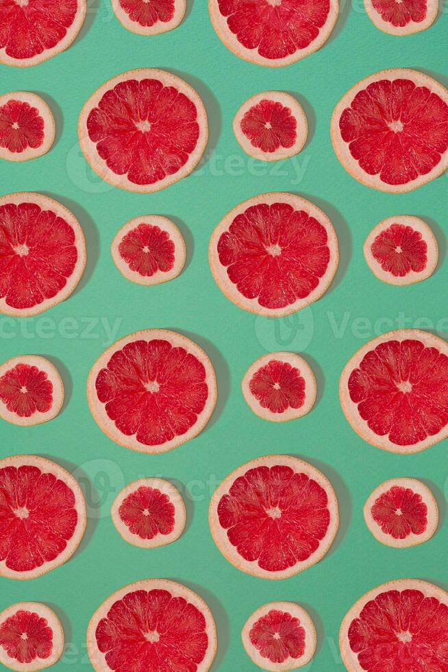 Grapefruit pattern isolated on blue background. Flat lay photo