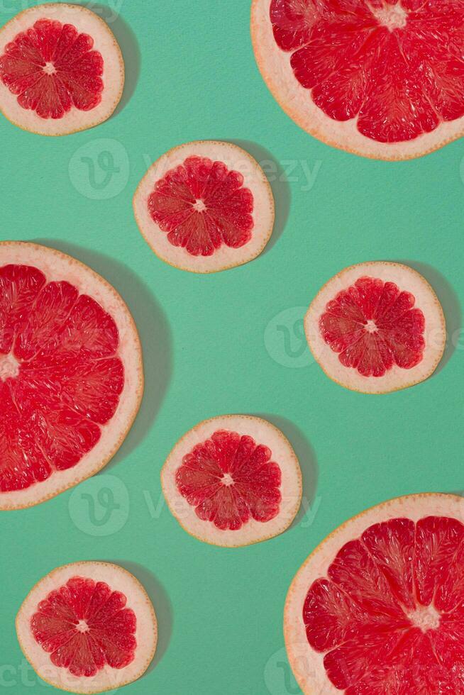 Grapefruit pattern isolated on blue background. Flat lay photo