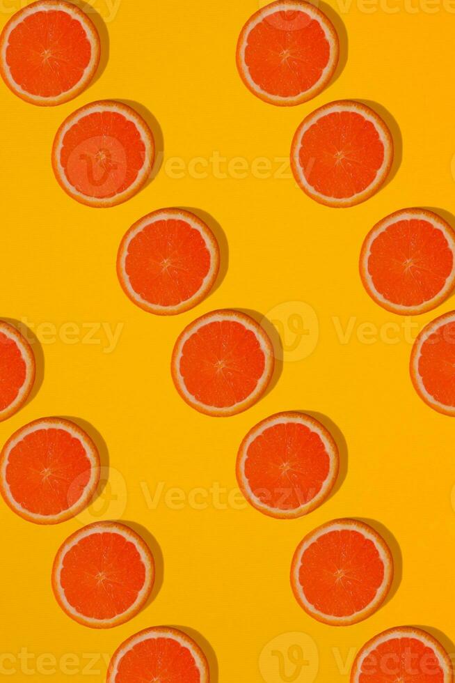 Grapefruit pattern on yellow background. Minimal flat lay concept. photo