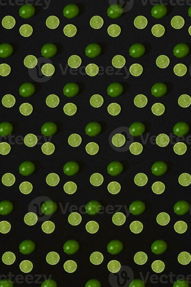 Lime pattern on black background. Minimal flat lay concept. photo