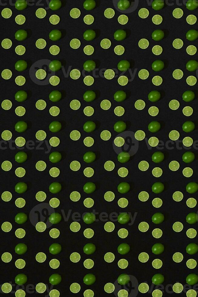 Lime pattern on black background. Minimal flat lay concept. photo