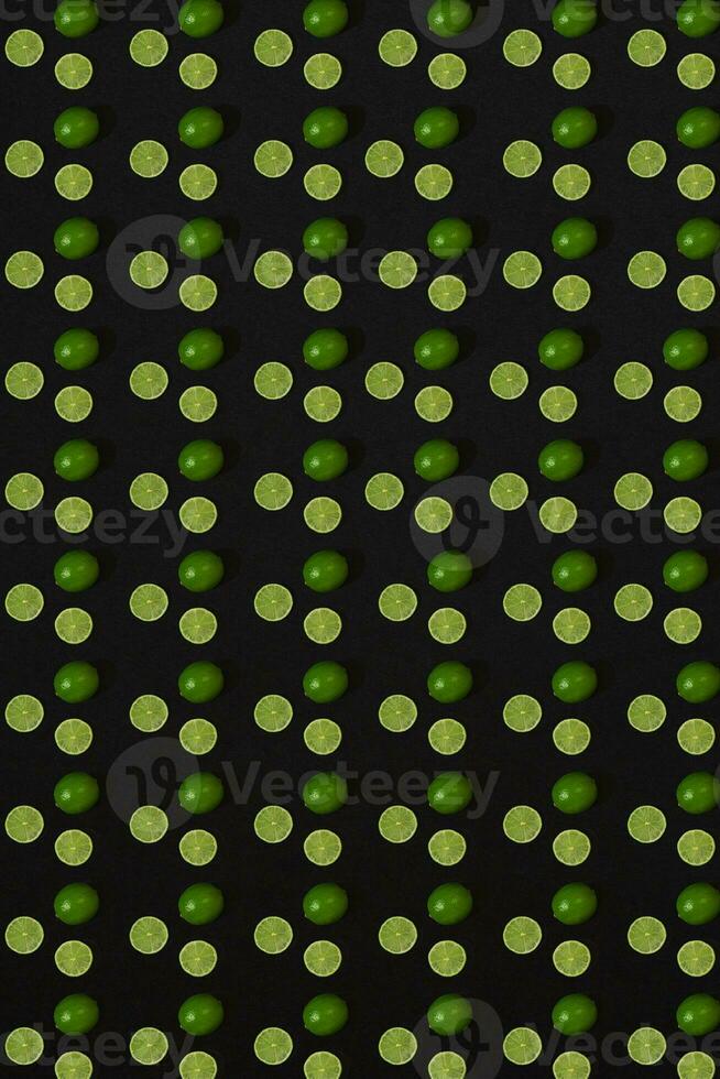 Lime pattern on black background. Minimal flat lay concept. photo