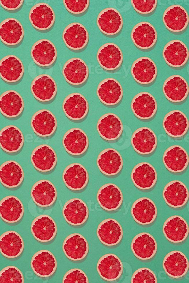 Grapefruit pattern isolated on blue background. Flat lay photo