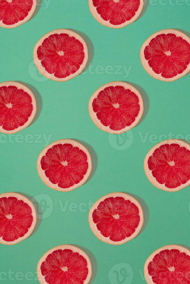 Grapefruit pattern isolated on blue background. Flat lay photo