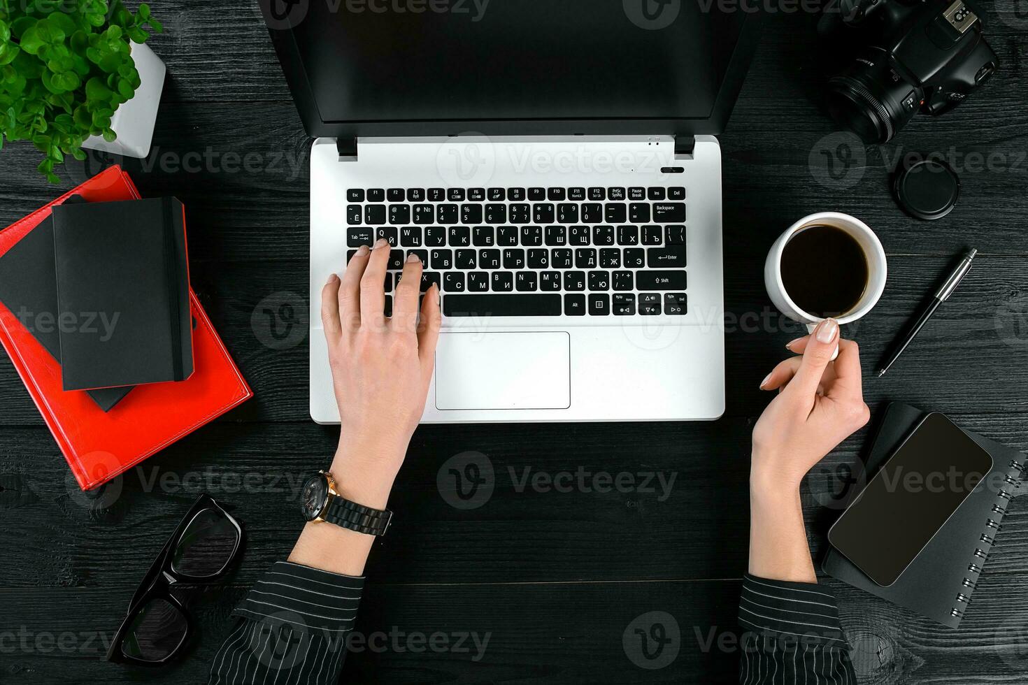 Mix of office supplies and gadgets on a wooden desk background. View from above. photo