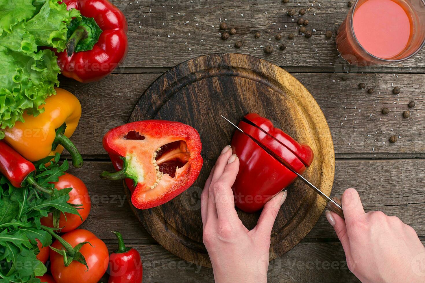 Female hands cutting pepper at table, top view photo