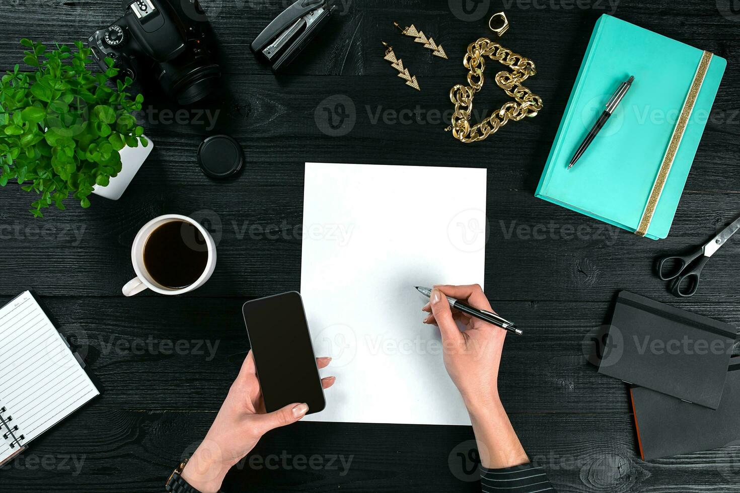 Mix of office supplies and gadgets on a wooden desk background. View from above. photo