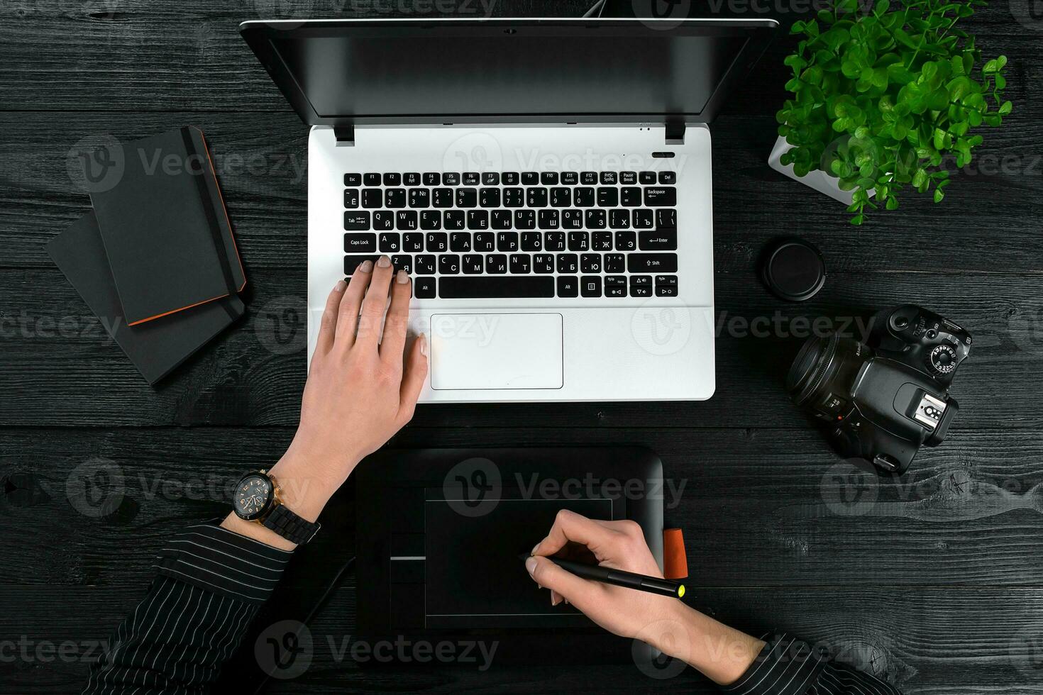 Mix of office supplies and gadgets on a wooden desk background. View from above. photo