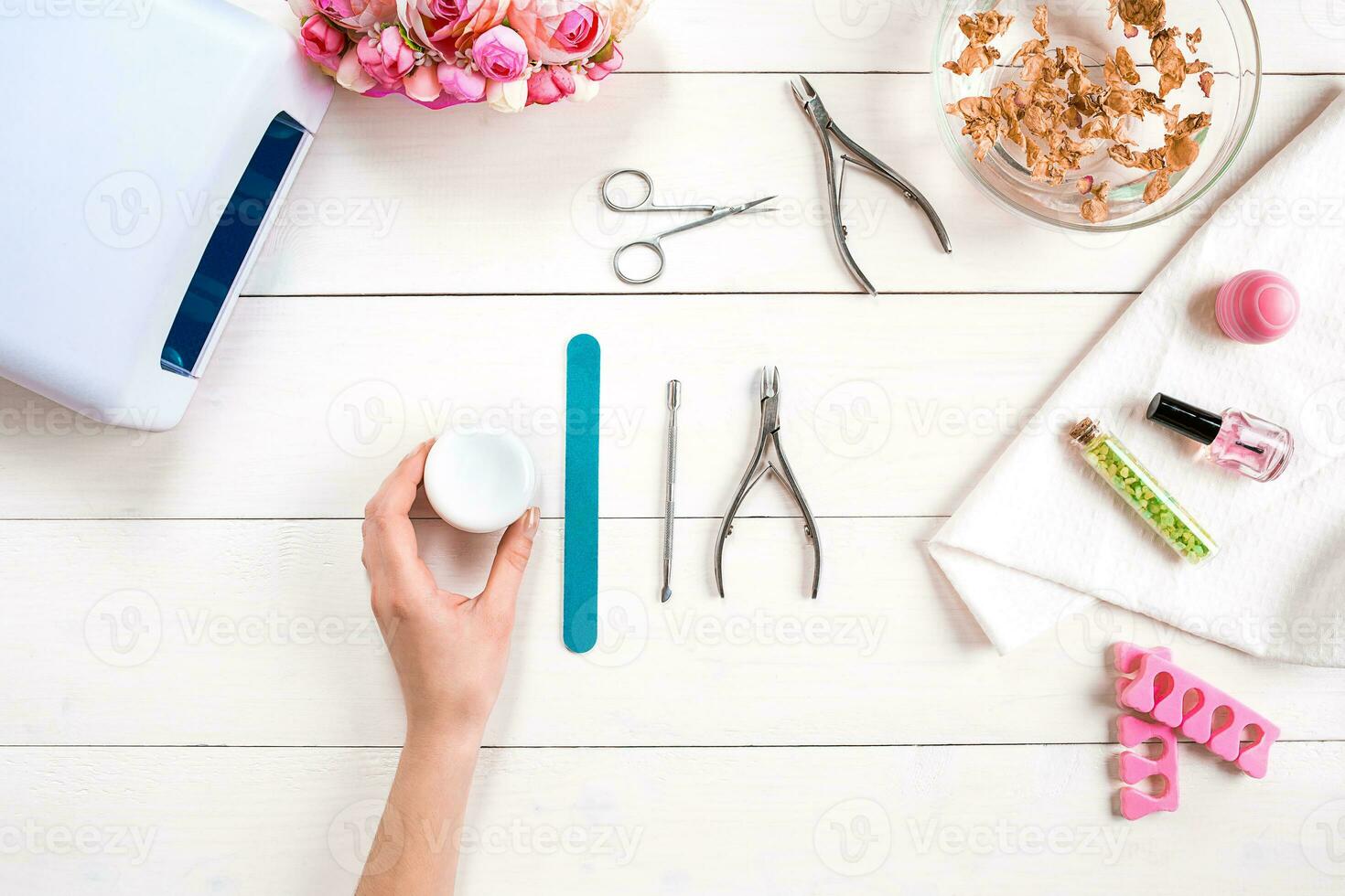 Manicure set and nail polish on wooden background photo