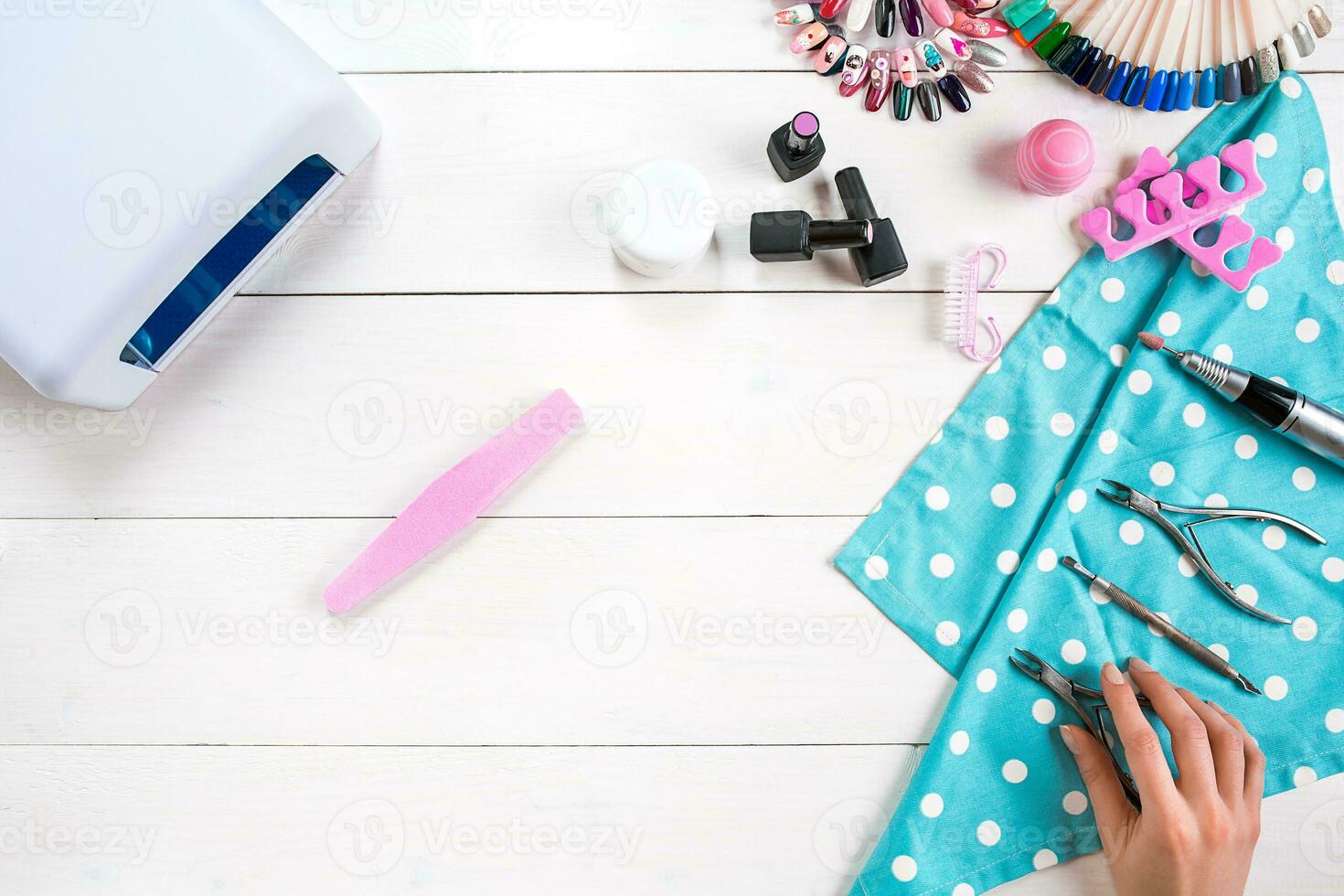 Manicure set and nail polish on wooden background photo