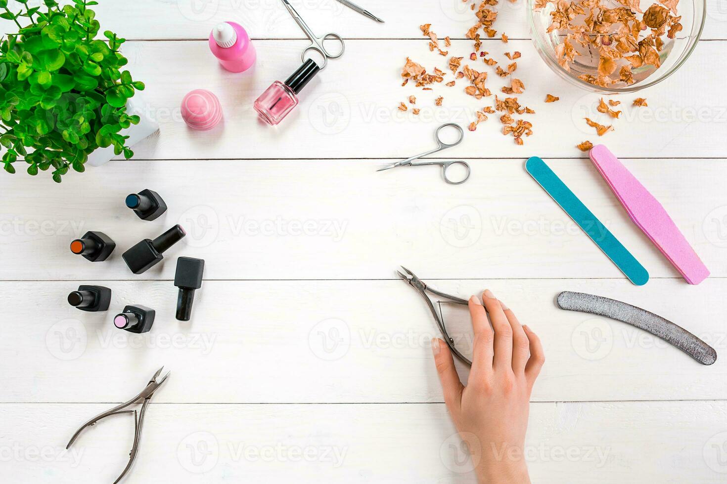 Woman Hands Care. Top View Of Beautiful Smooth Woman's Hands With Professional Nail Care Tools For Manicure On White Background. photo