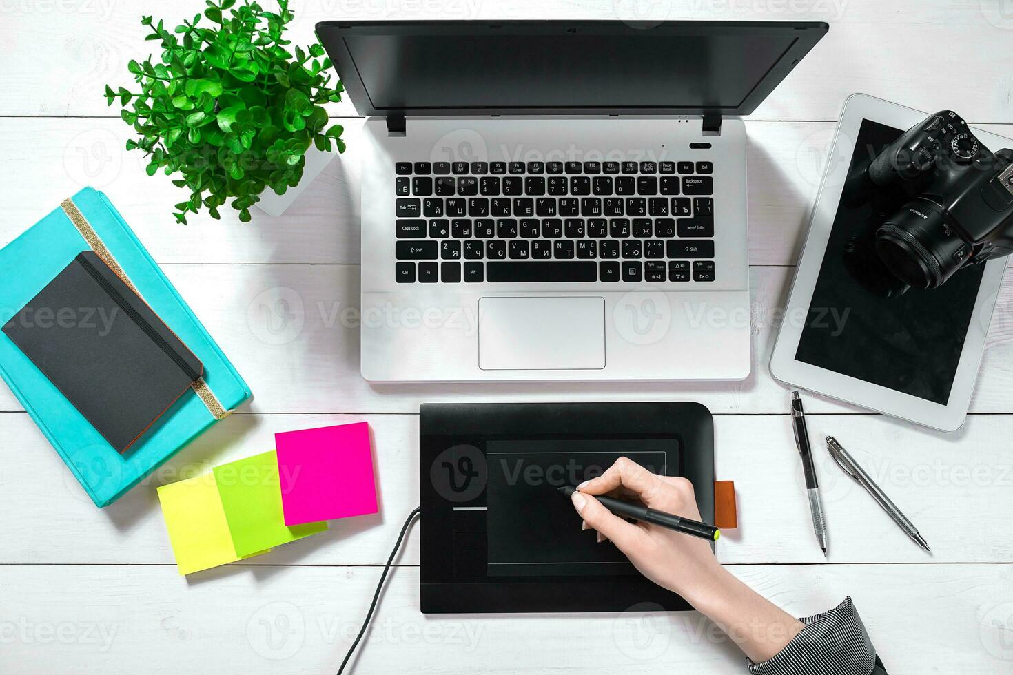 Laptop with blank screen and girl's hands. Flat lay, top view workspace photo