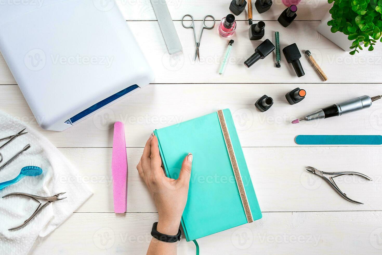 Manicure set and nail polish on wooden background photo