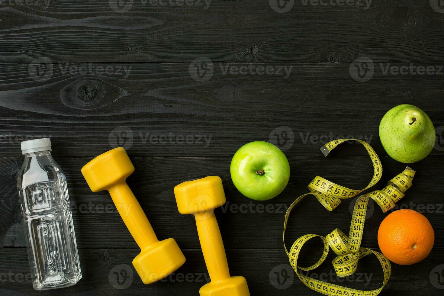 Workout plan with fitness equipment on dark background, top view photo