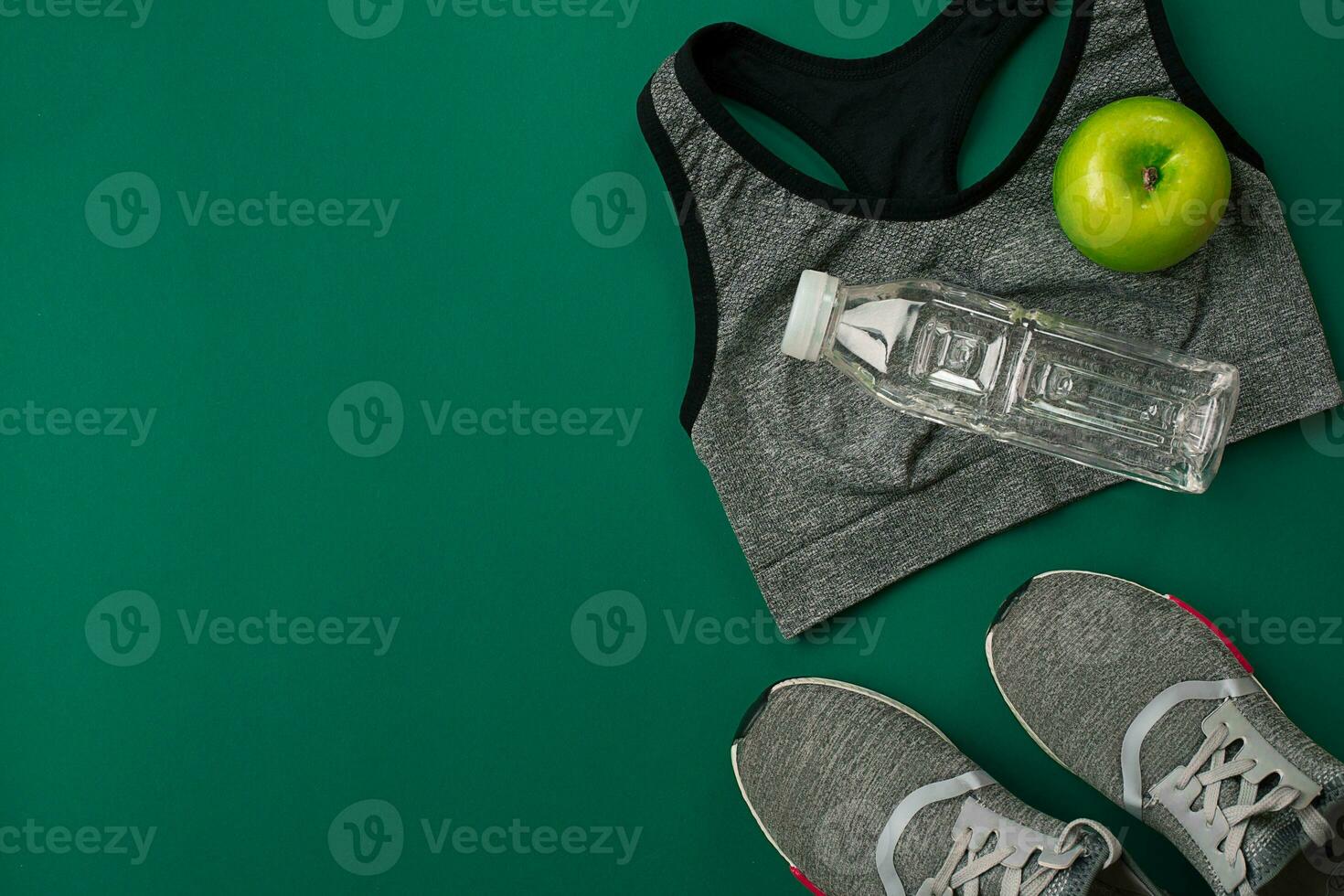 Sports accessories for fitness on the green floor. Healthy lifestyle concept. photo