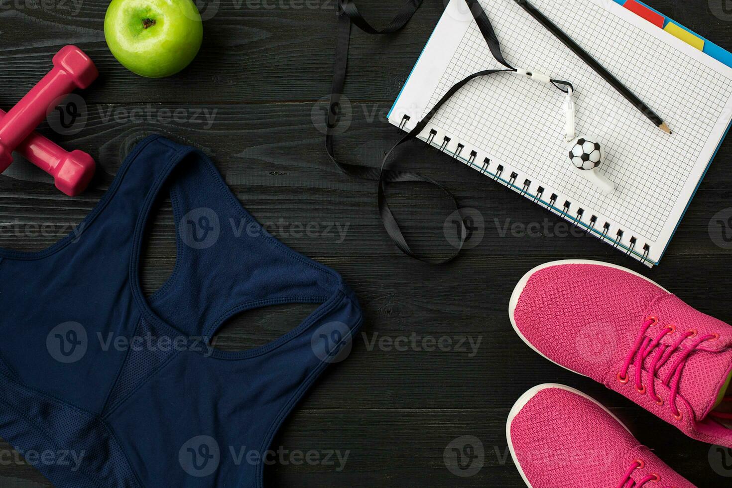 Workout plan with fitness food and equipment on dark background, top view photo