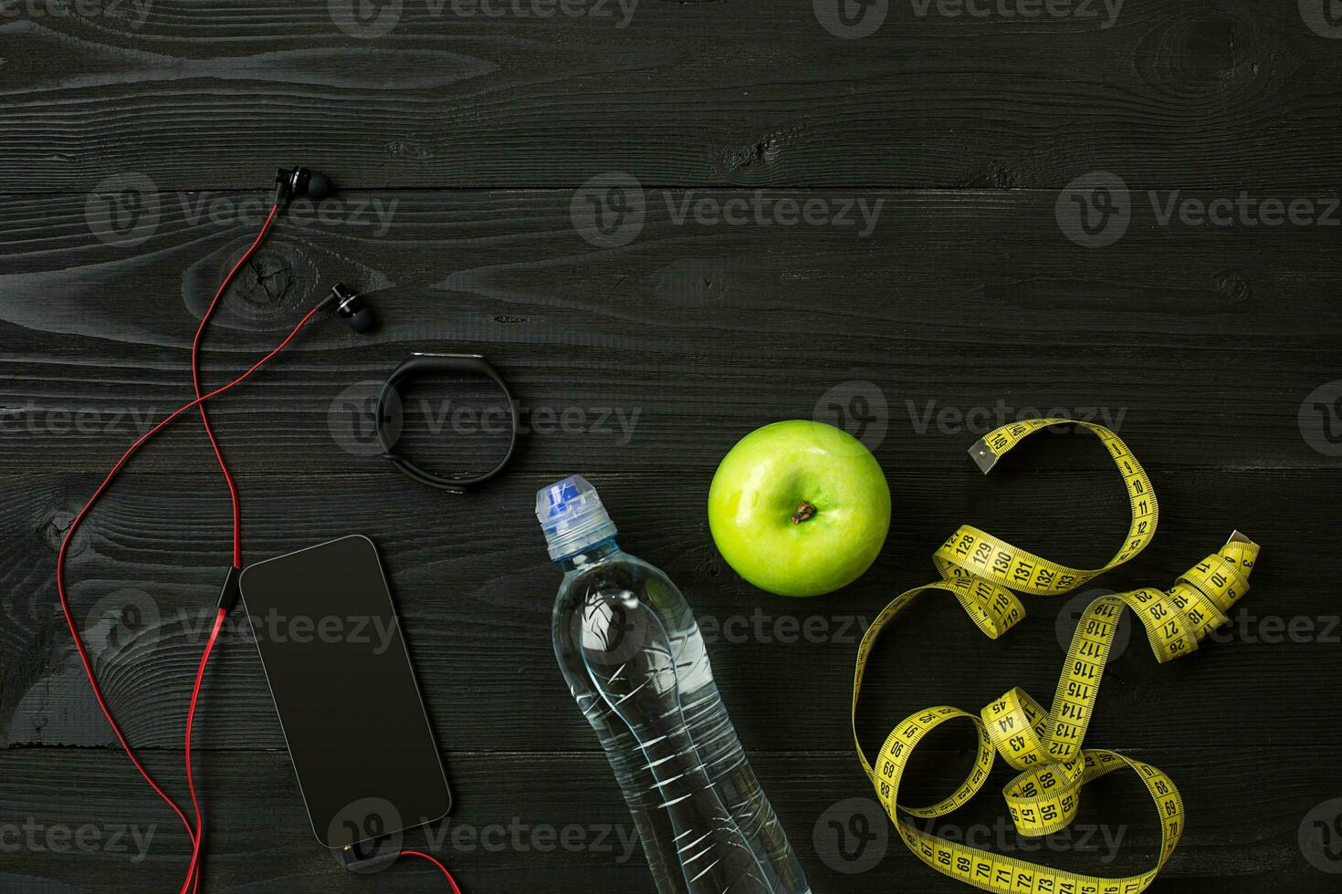 Athlete's set with bottle of water on dark background photo