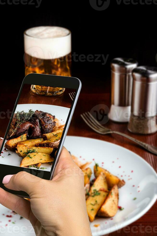 A young woman taking photo of food on smartphone, photographing meal with mobile camera