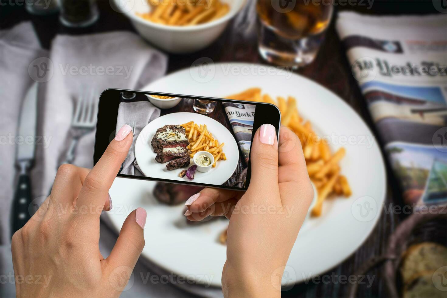 A young woman taking photo of food on smartphone, photographing meal with mobile camera