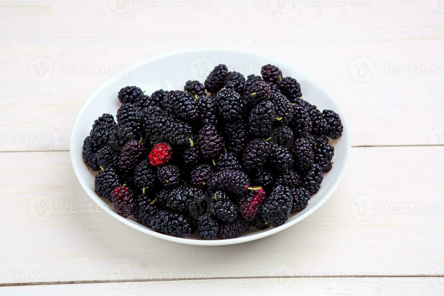 mulberry in white plate, top view photo