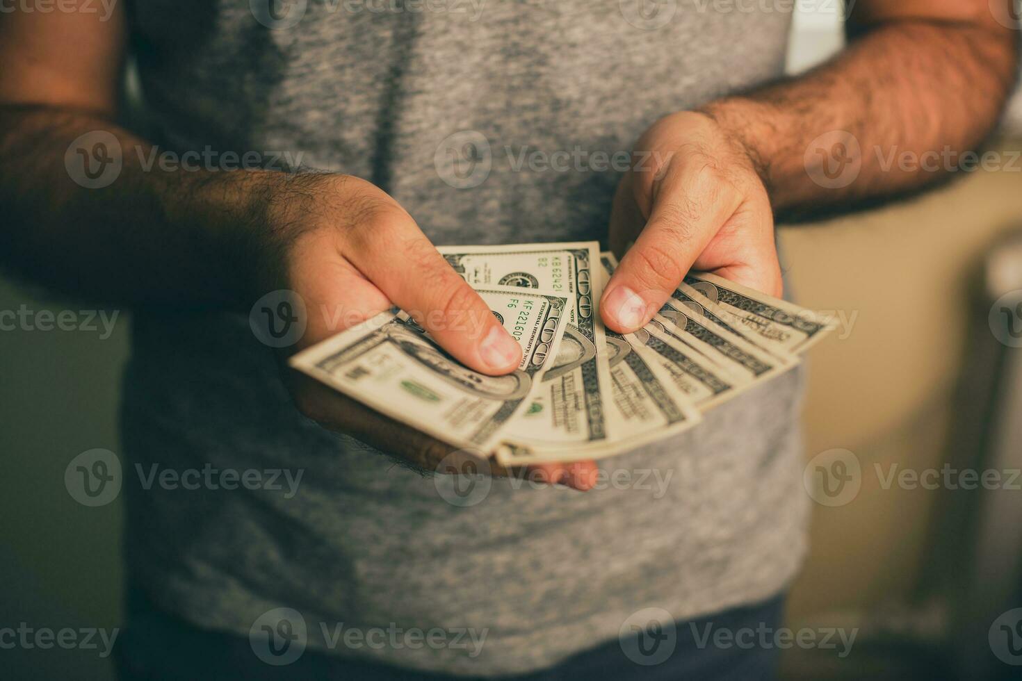 A man holds dollars in his hands photo