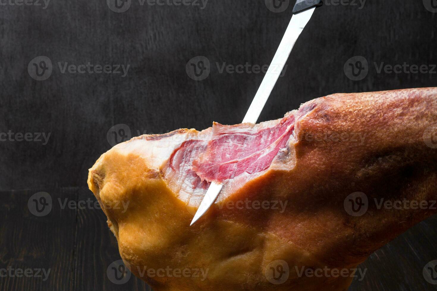 Jamon. Jamon serrano. Traditional Spanish ham on black close up. photo