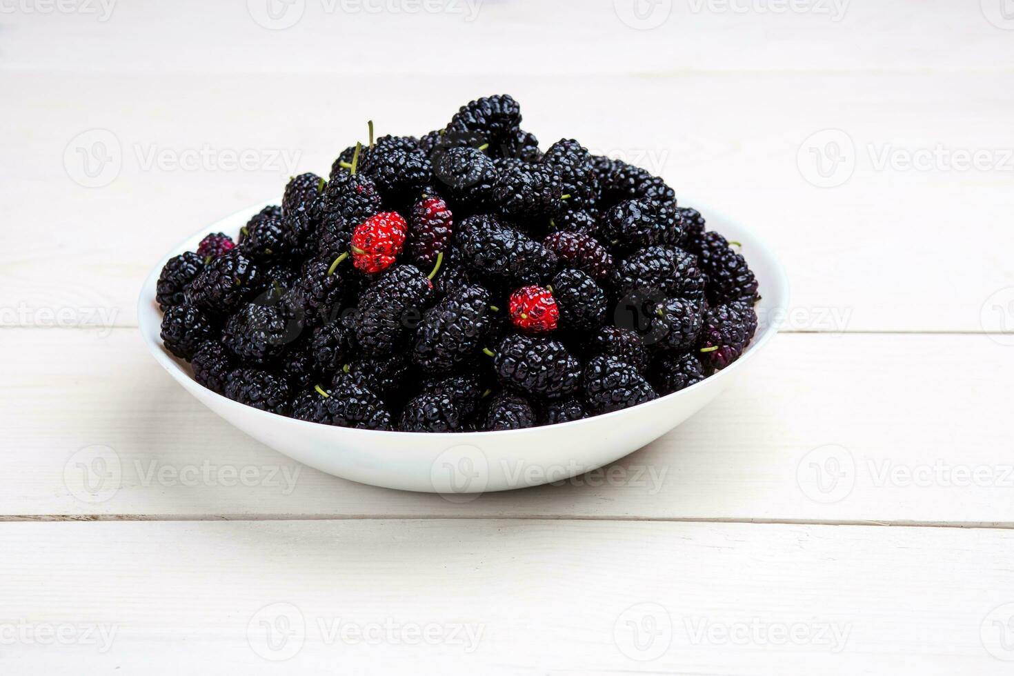 mulberry in white plate, top view photo