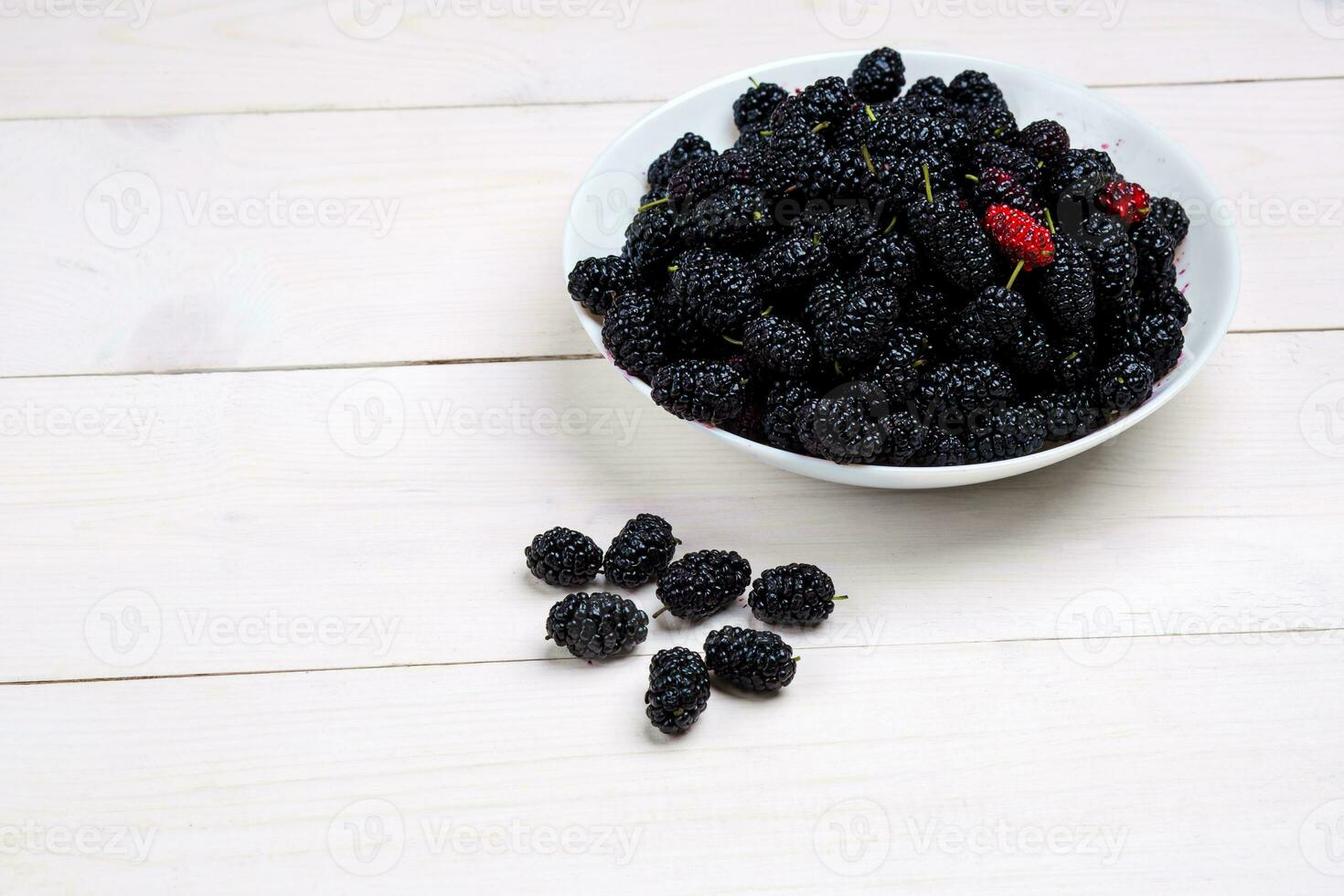 mulberry in white plate, top view photo