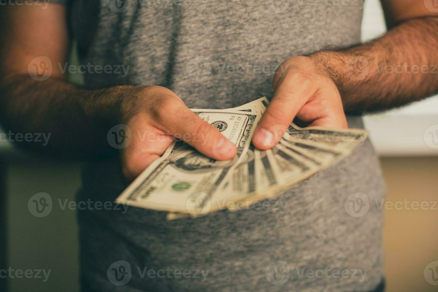 A man holds dollars in his hands photo