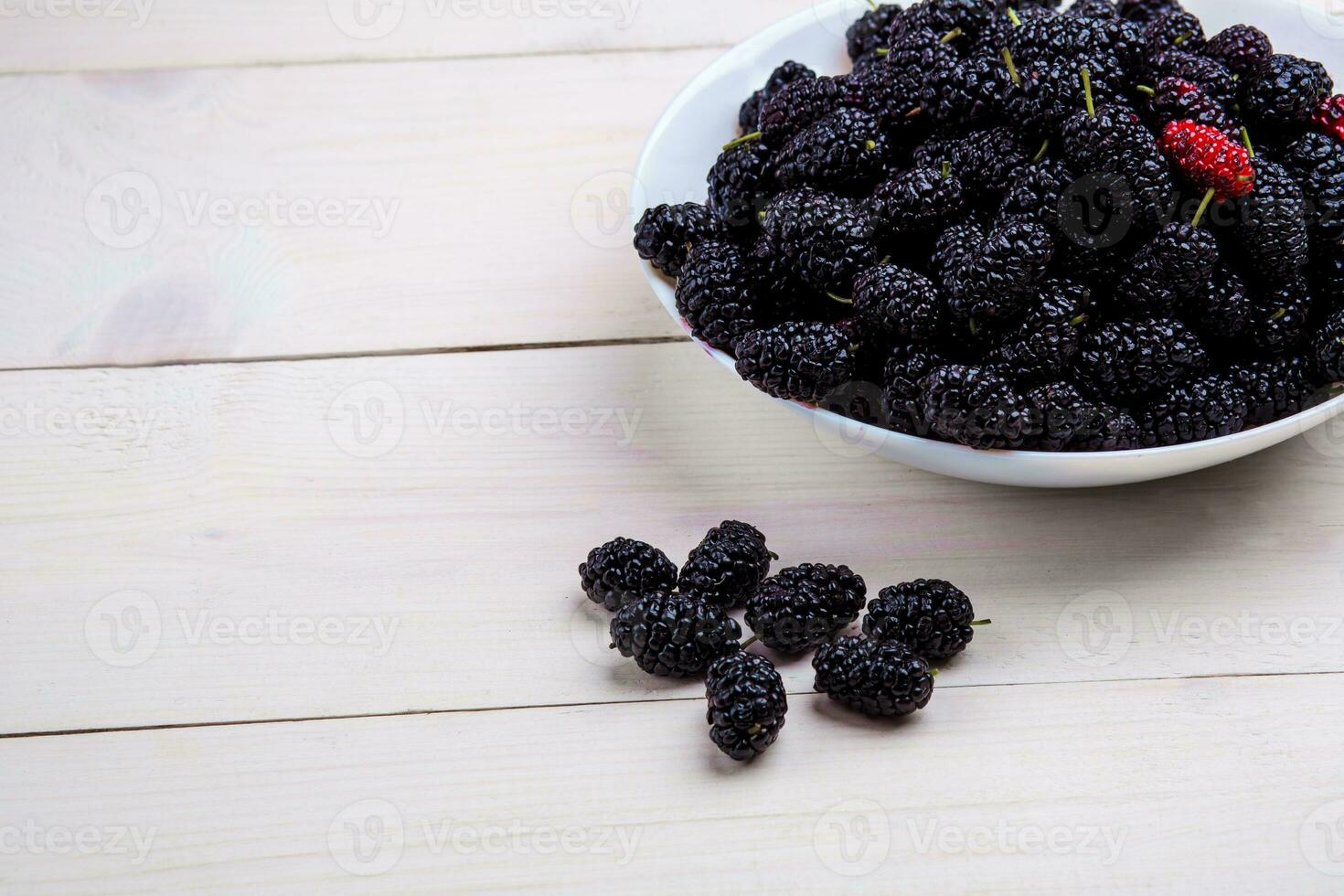 mulberry in white plate, top view photo