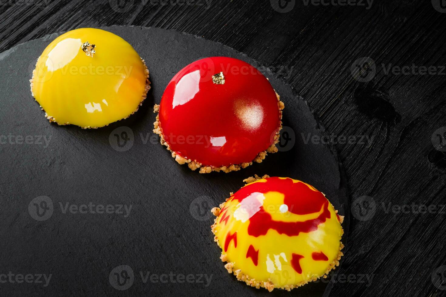 Beautiful cakes covered with glossy red and yellow glaze. Concept design pastry desserts photo