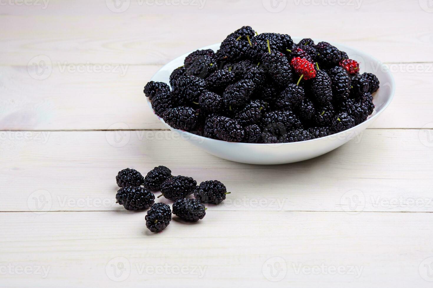 mulberry in white plate, top view photo