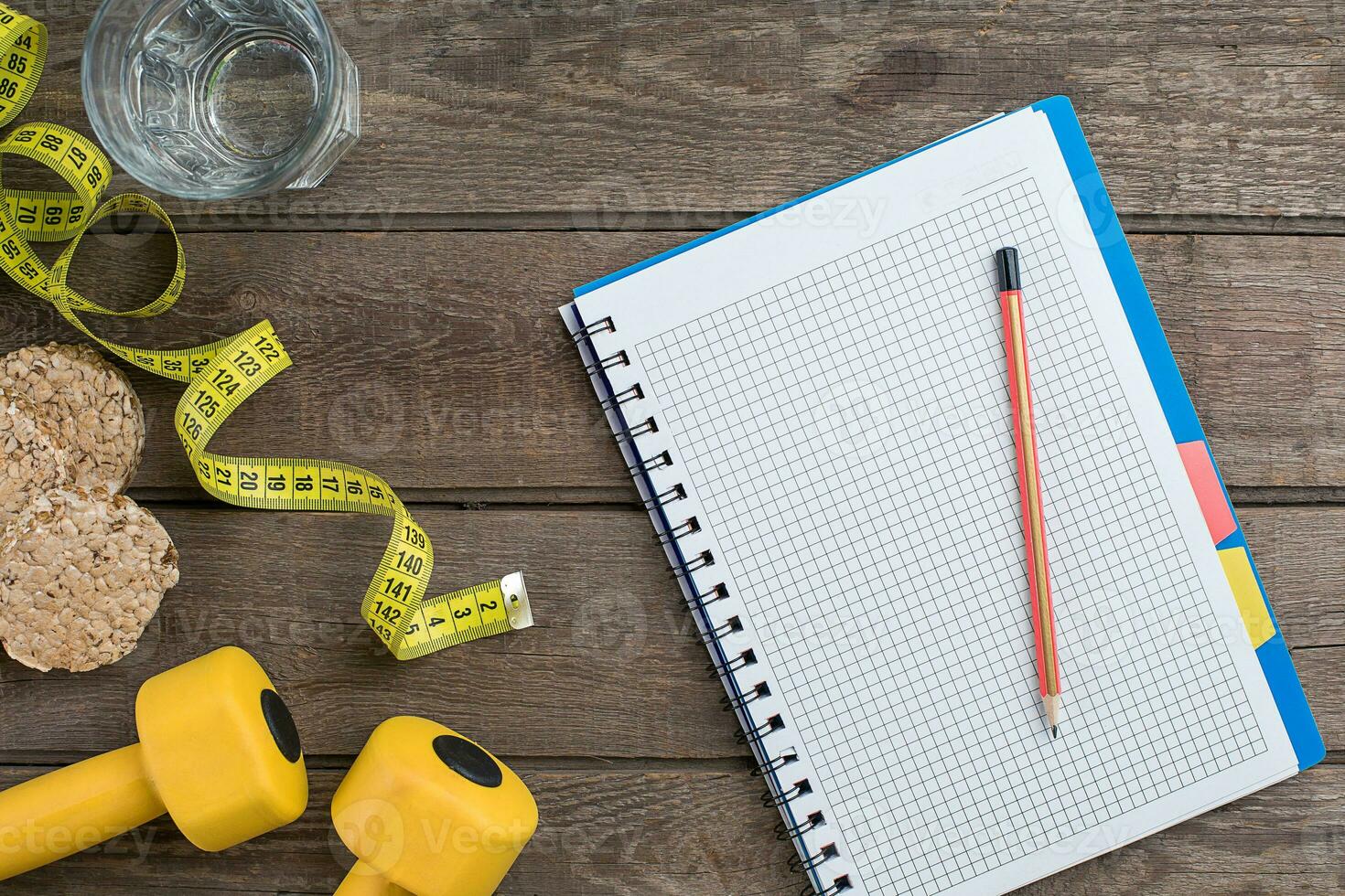 Glass of water with vegetables and measuring tape on table close-up photo