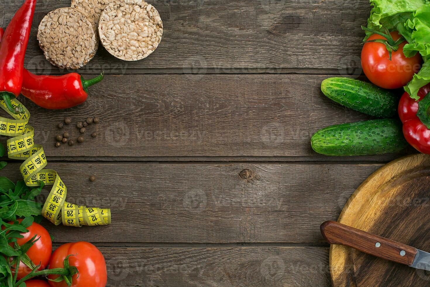 Sport and diet. Vegetables and centimeter. Peppers, tomatoes, salad on rustic background photo