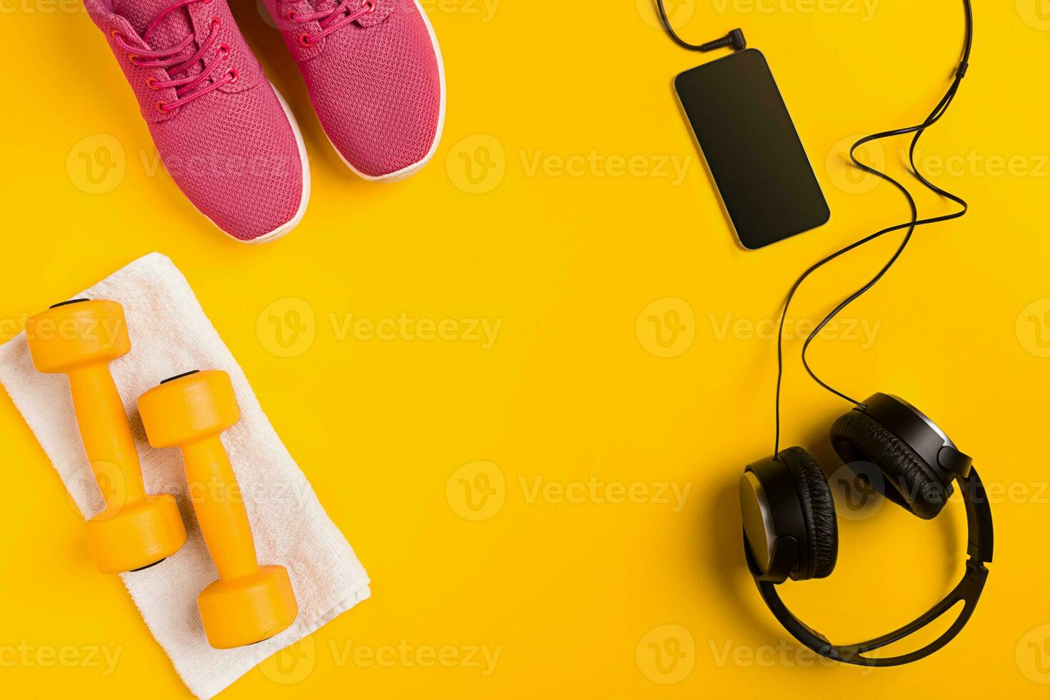 Athlete's set with female clothing, dumbbells and bottle of water on yellow background photo