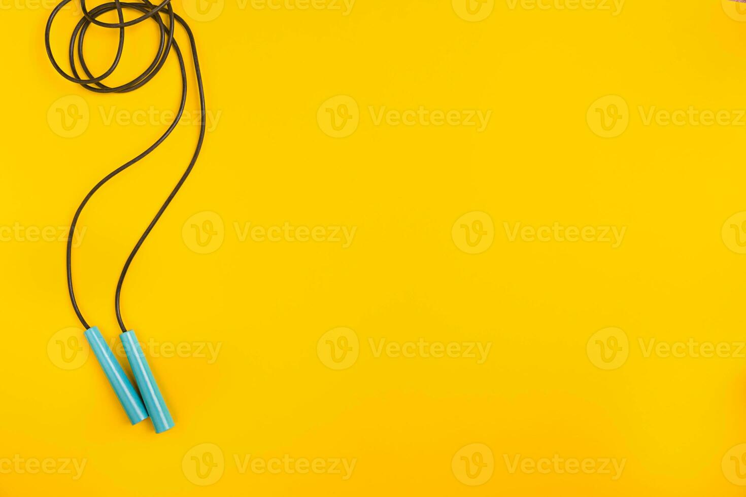 Top view of Skipping rope on yellow background photo