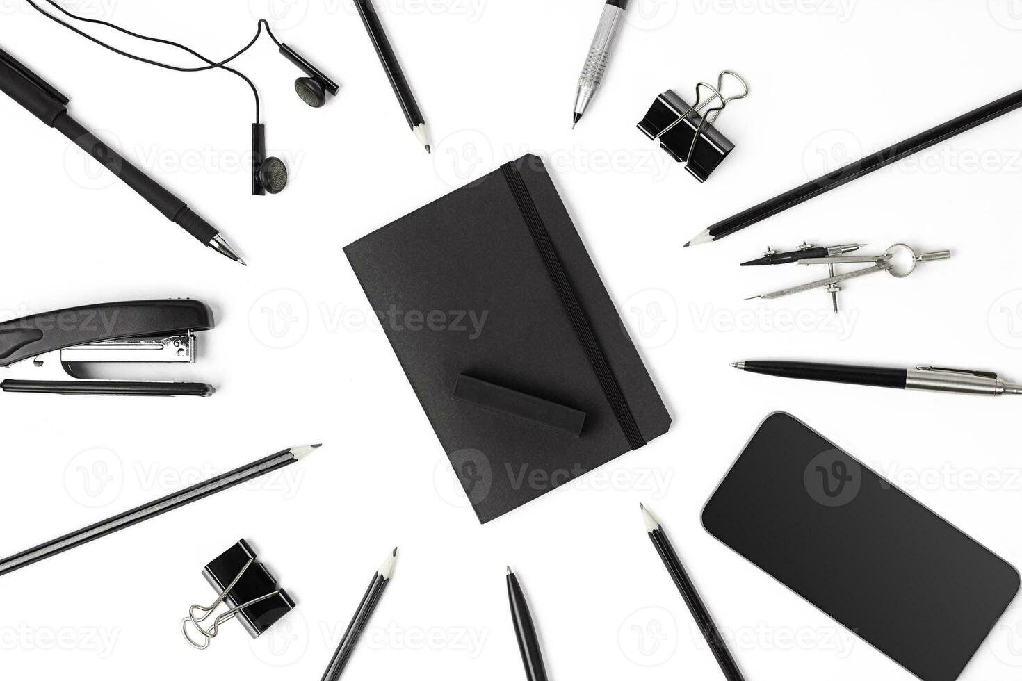 Blank notepad with clips, pens and glasses flat lay. photo