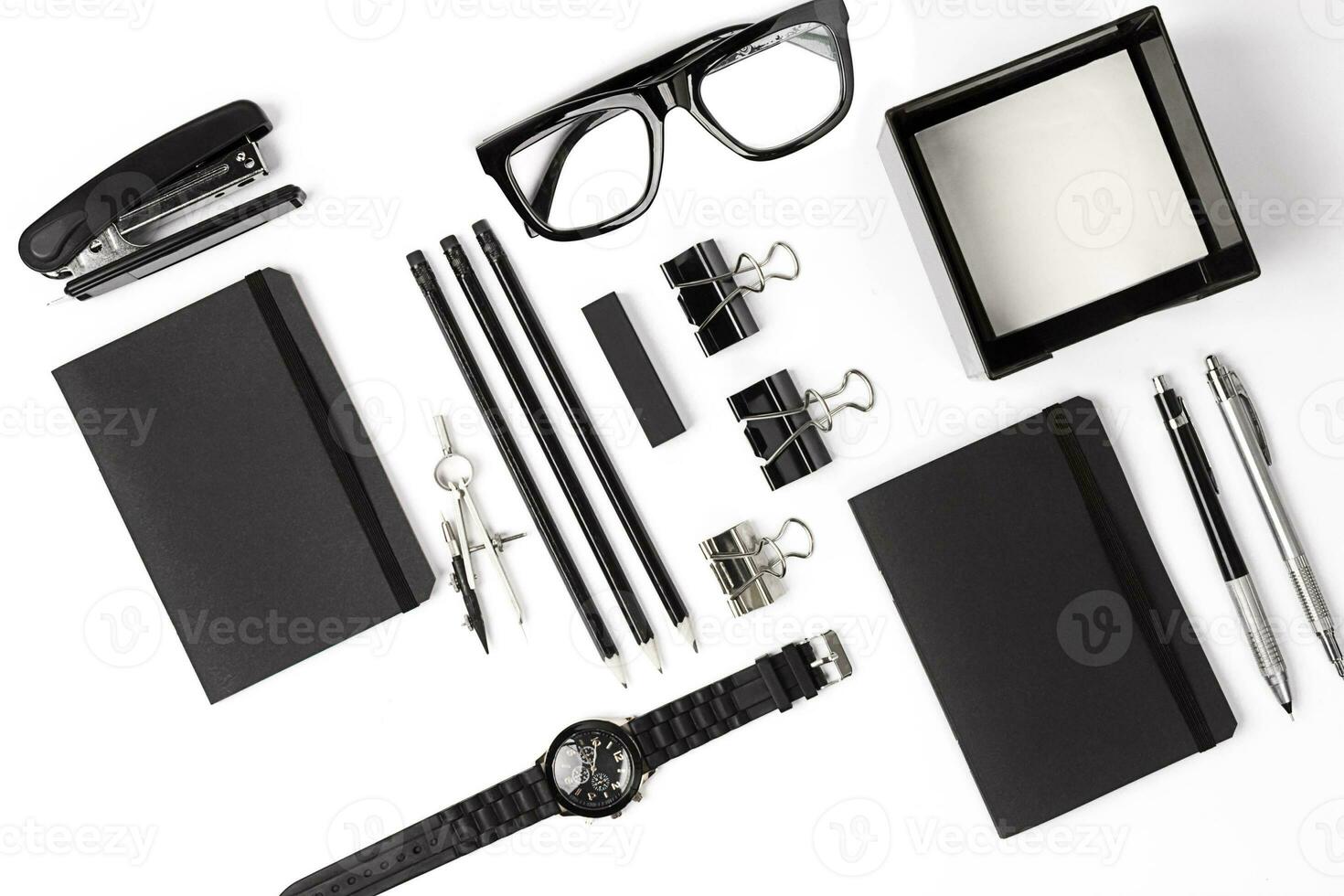 Blank notepad with clips, pens and glasses flat lay. photo