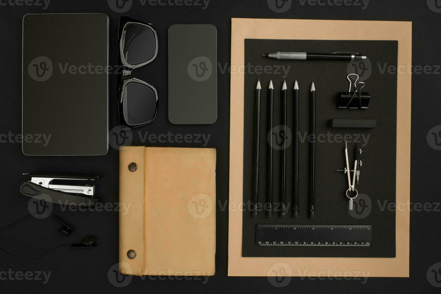 Office desktop with various black objects on background photo