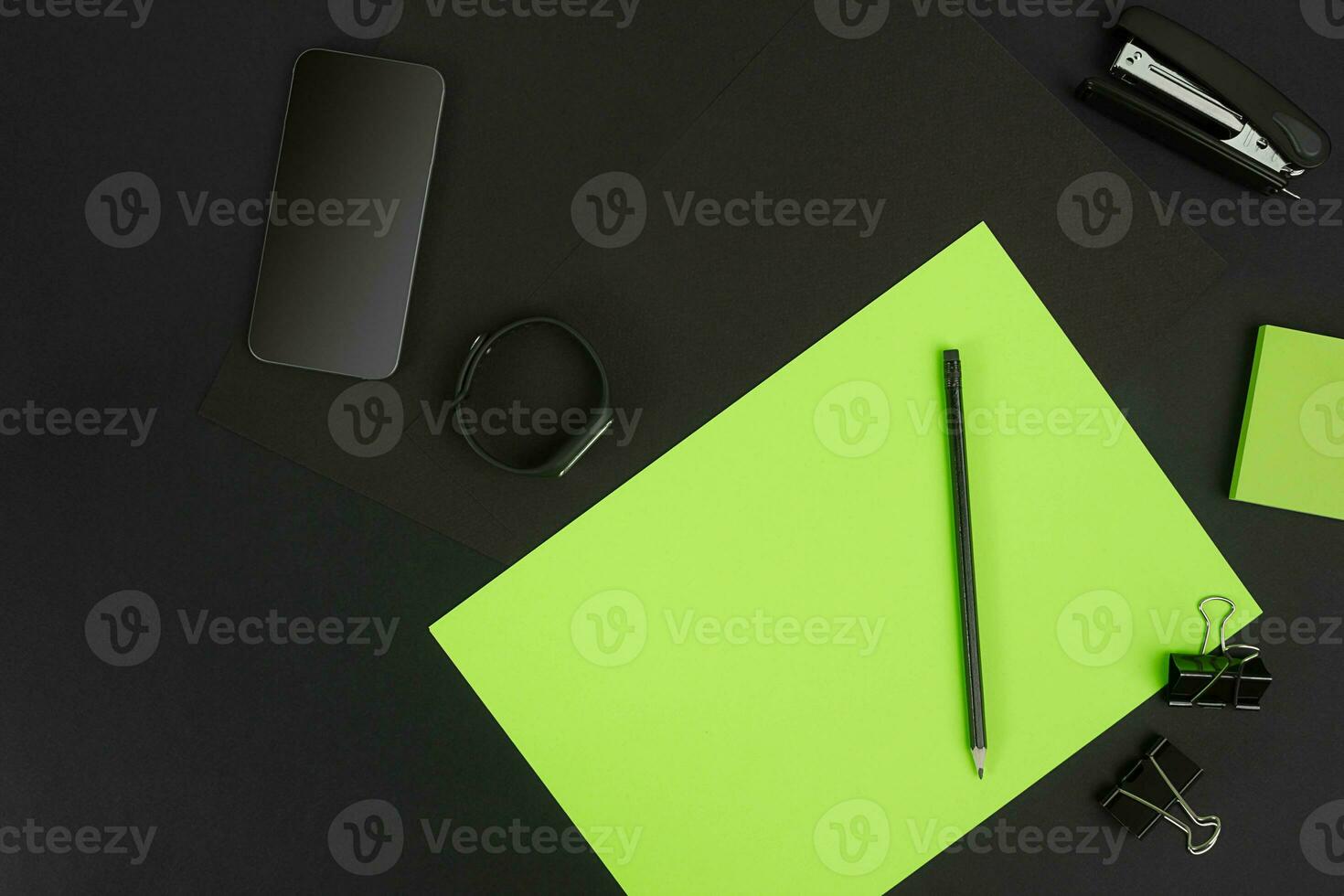 Top view of office supplies on blackboard background with copy space. photo