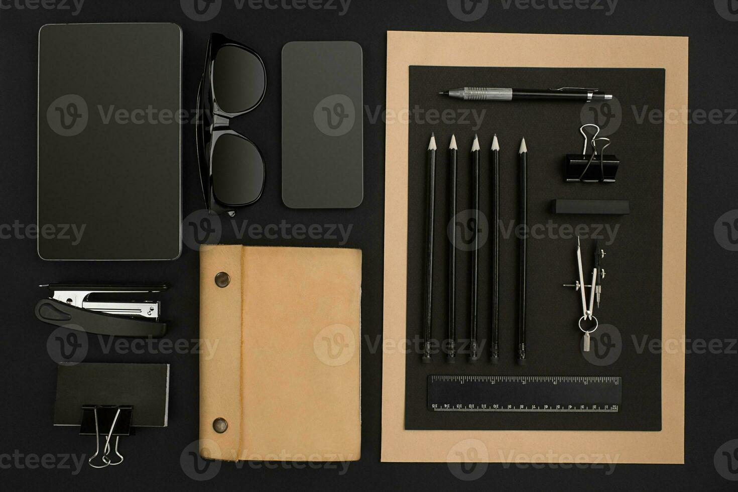 Office desktop with various black objects on background photo