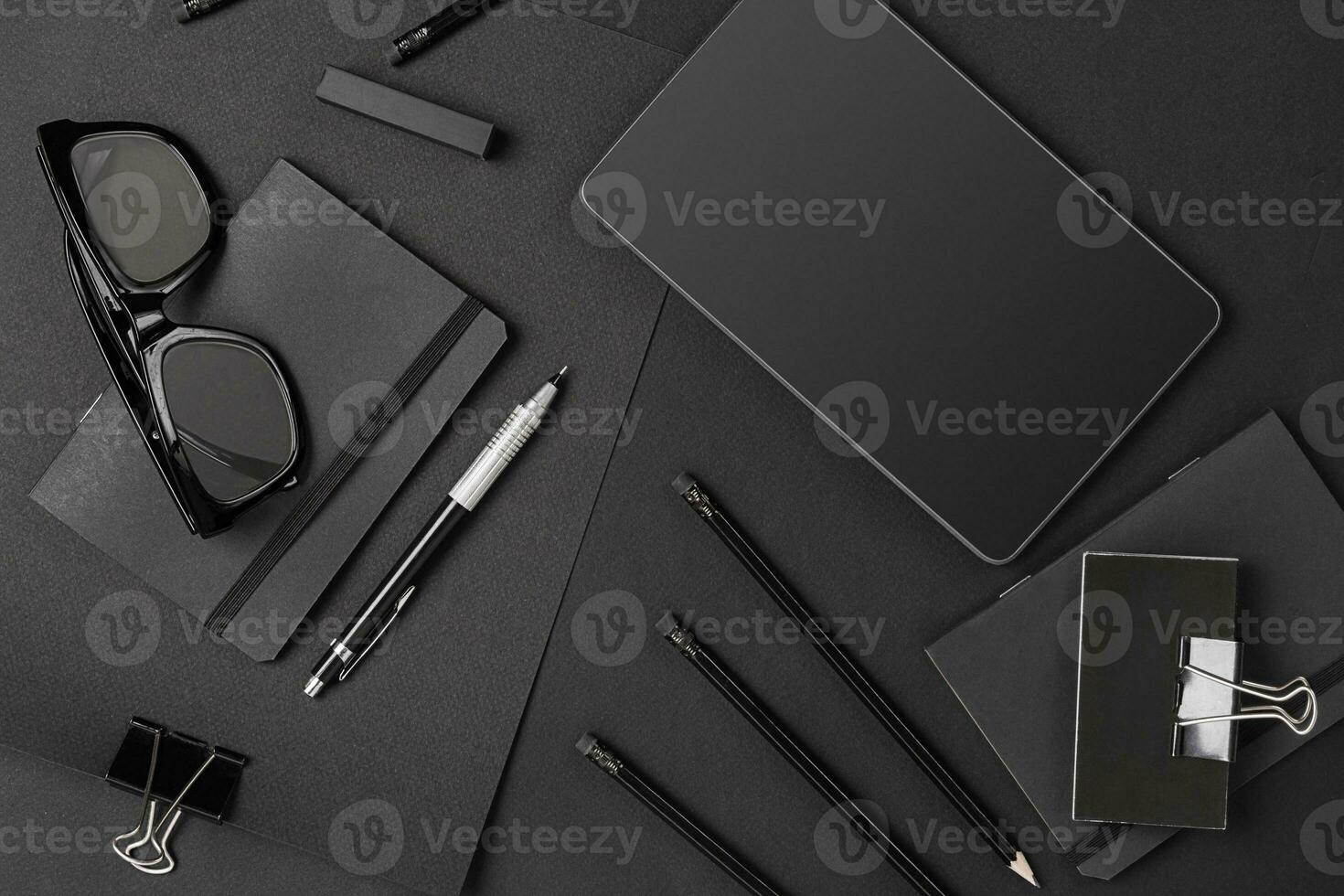 Mix of office supplies and business gadgets on a modern desk photo