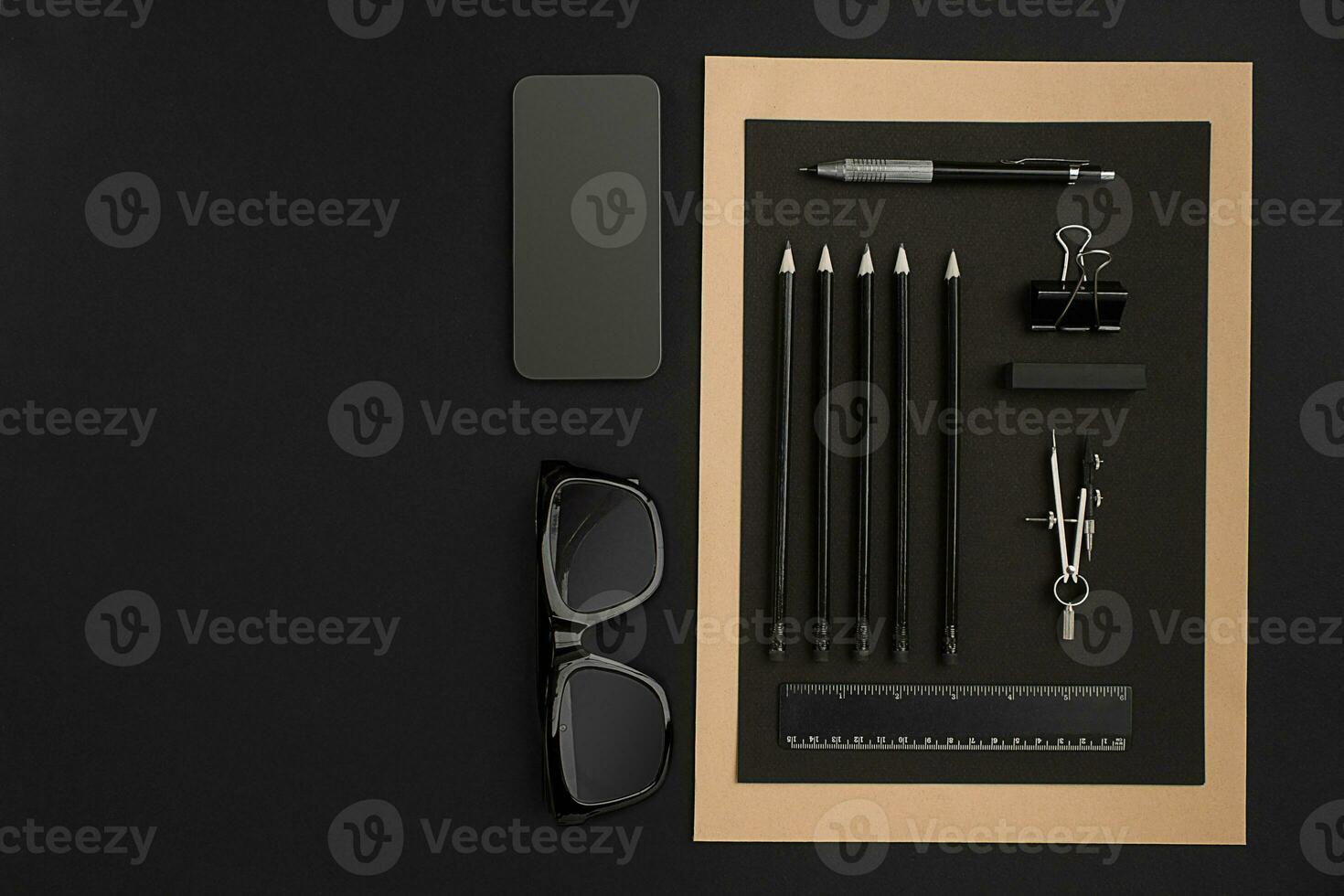 Office desktop with various black objects on background photo